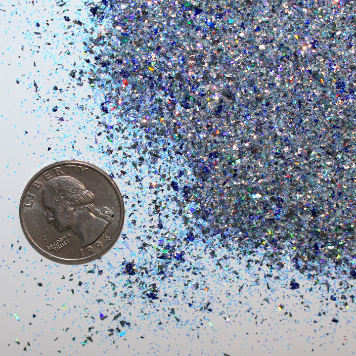 Blue holographic shard-cut glitter called “All I Want For Christmas Is A Nap,” packaged in a 5 gram bag, part of the Christmas Is Here glitter collection, perfect for nails, resin art, tumblers, ornaments, hair, body, and holiday crafts.