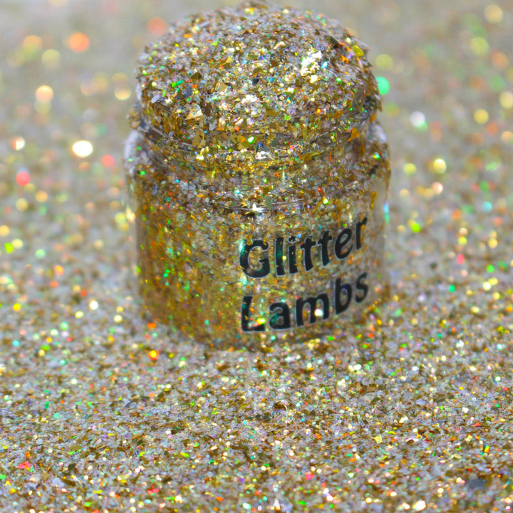 Gold holographic shard glitter called “Dear Santa, Define Good!,” packaged in a 5 gram bag, part of the Christmas Is Here glitter collection, perfect for nails, resin art, tumblers, ornaments, hair, body, and holiday crafts.