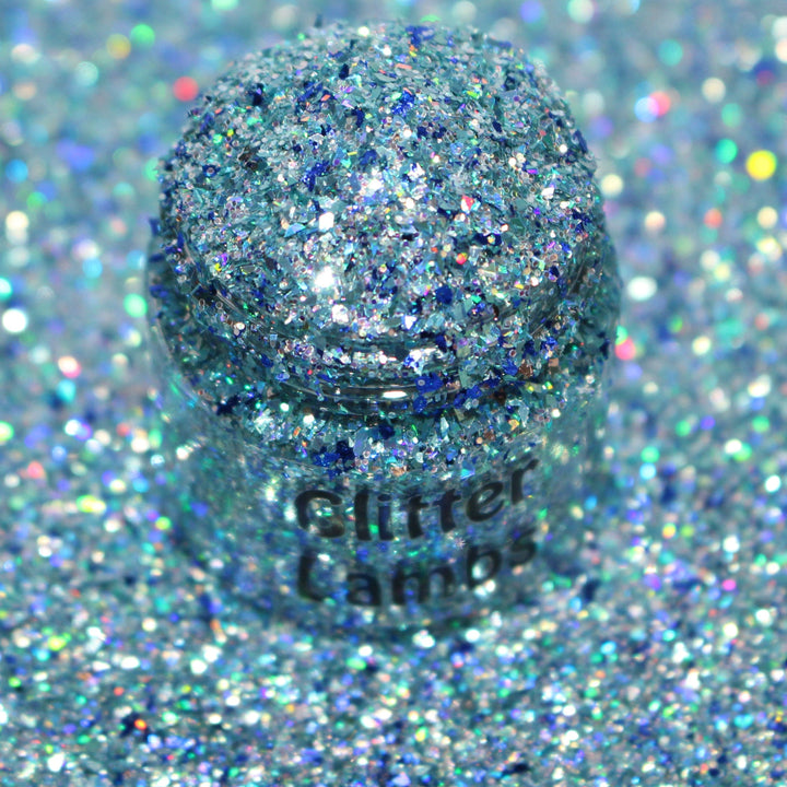 Icy blue shard glitter called “I Just Want To Watch Christmas Movies” in a 5 gram bag, part of the Christmas Is Here glitter collection, perfect for nails, resin art, tumblers, and holiday crafts.