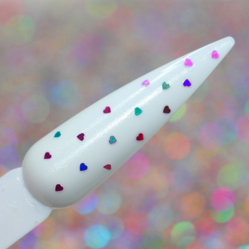 Pixie Hearts glitter on a nail by GlitterLambs.com Holographic and matte tiny 1mm heart glitters (.040) size of heart glitter. Very tiny. Nail art, Nail Artist, Nail Glitter Supplier.