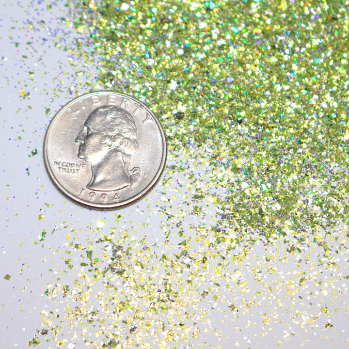 Gold holographic shard glitter called “Pour Me Some Holiday Cheer,” packaged in a 5 gram bag, part of the Christmas Is Here glitter collection, perfect for nails, resin art, tumblers, ornaments, hair, body, and holiday crafts.